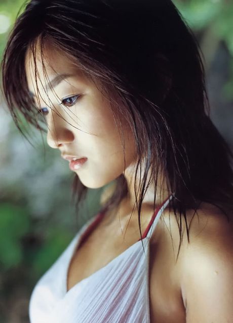 Beautiful asian girl having fun at the beach in a bikini