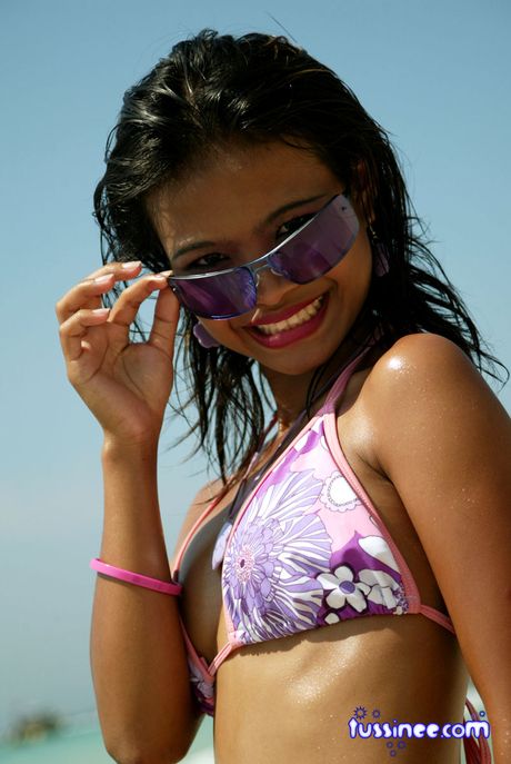 Asian teen model at the beach poses on a Jet Ski