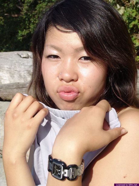 Young Sugar is having a smoke outdoors wearing only her birthday suit