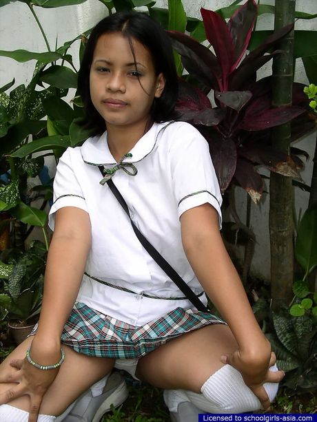 Very cute Asian student stripping outdoors to flash her bald pussy