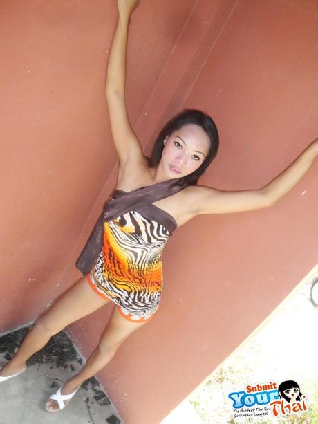 Slim Thai girlfriend flashing outdoors by the side of the road