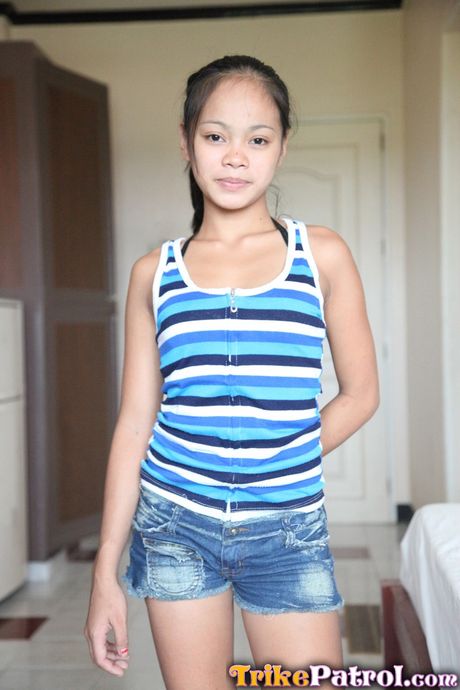 Asian amateur teen with tiny tits strips and shows her hairy cunt