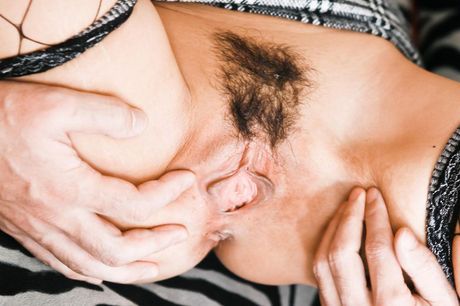 Rika Kurachi Asian in fishnet stockings sucks two hard dicks