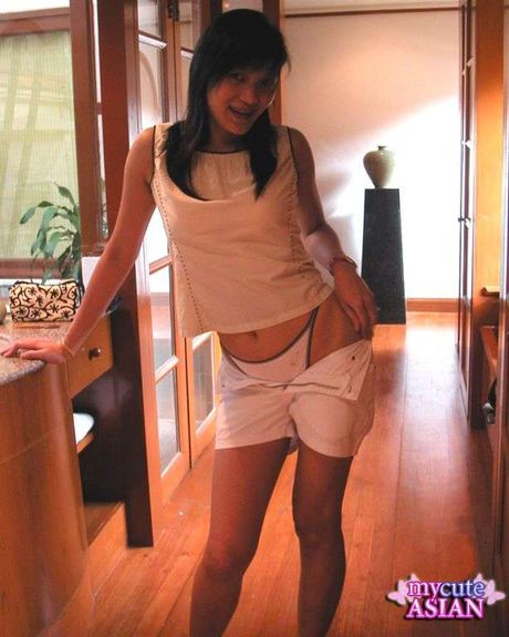 Amateur Asian teenager strips and toys her pussy with a dildo